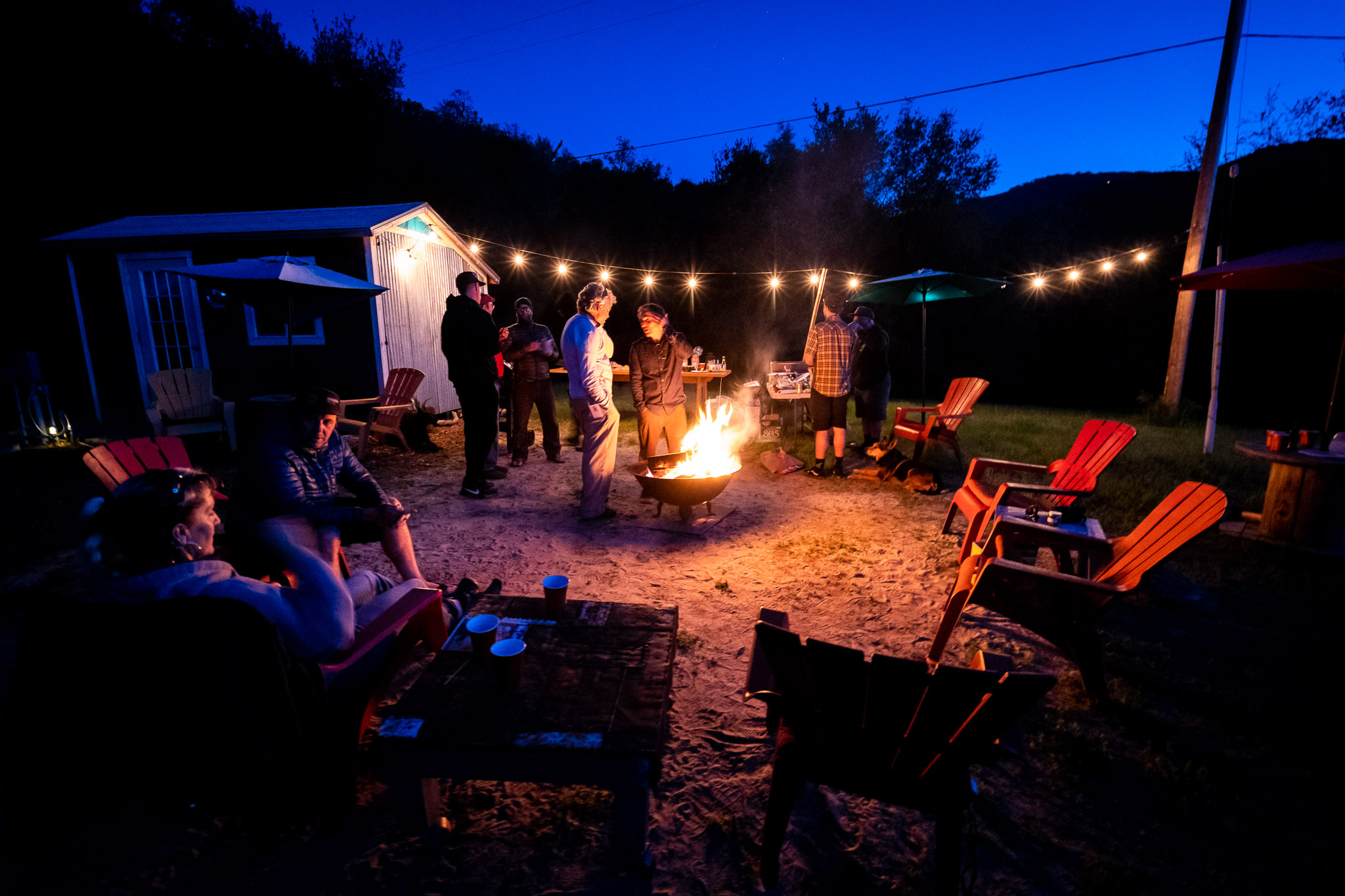 People gathered around the fire in the evening at the 2019 OTE Pre Otter party at Solosjuntos near Monterey.