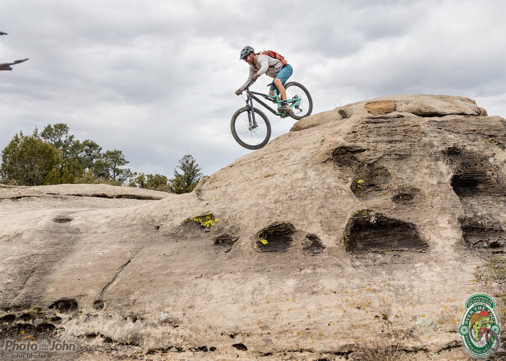 A mountain biker rolling down a rock dome in Southern Utah. 