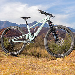 Thumbnail photo of a mint-green mountain bike in a Southern Utah desert landscape.
